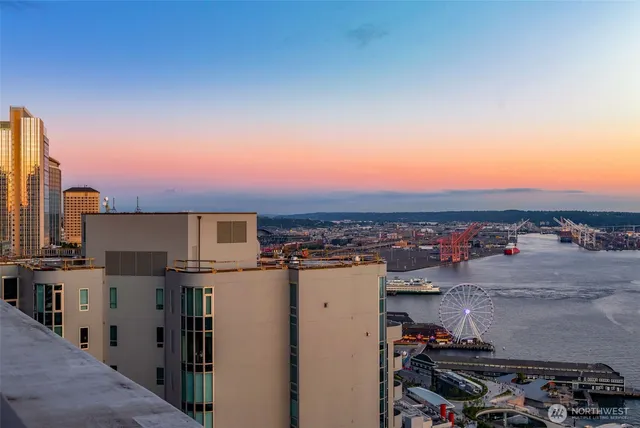 a living room with furniture a fireplace and a floor to ceiling window