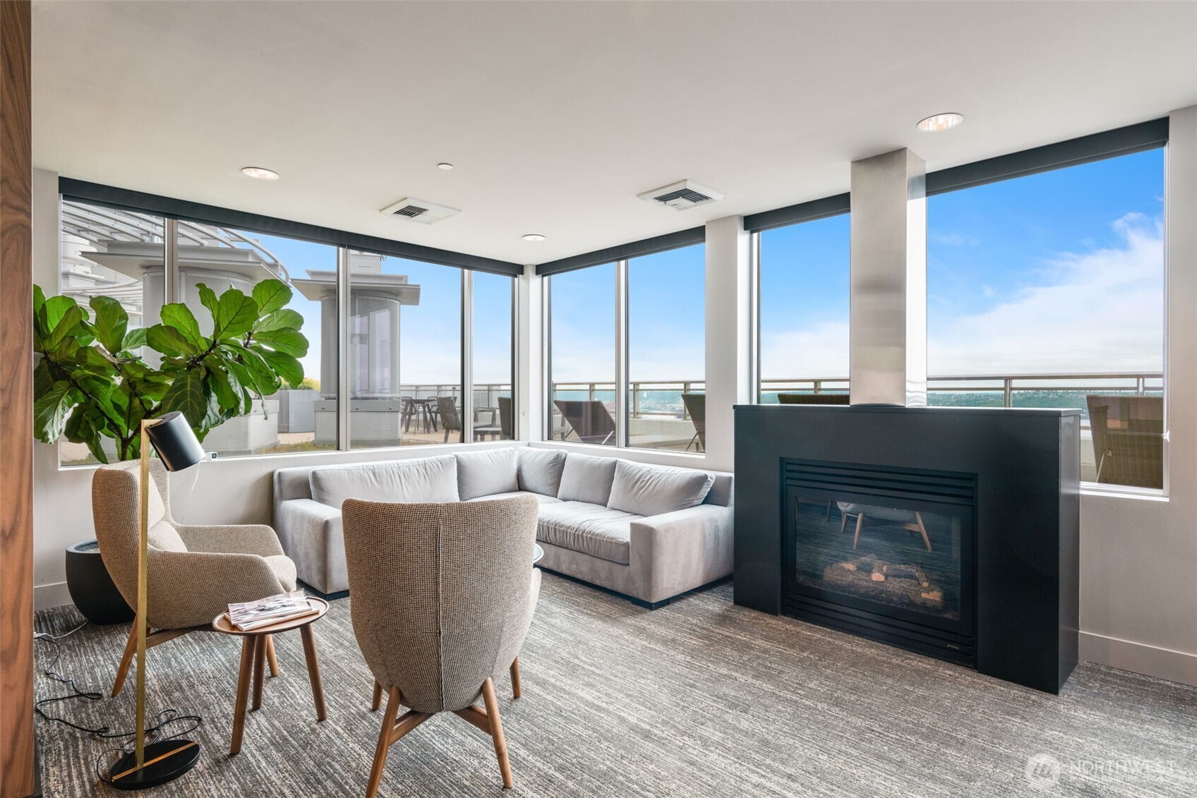 2033 2nd Avenue, Unit 1111 Seattle, WA 98121 - Photo 33 of 40 a living room with furniture a fireplace and a floor to ceiling window