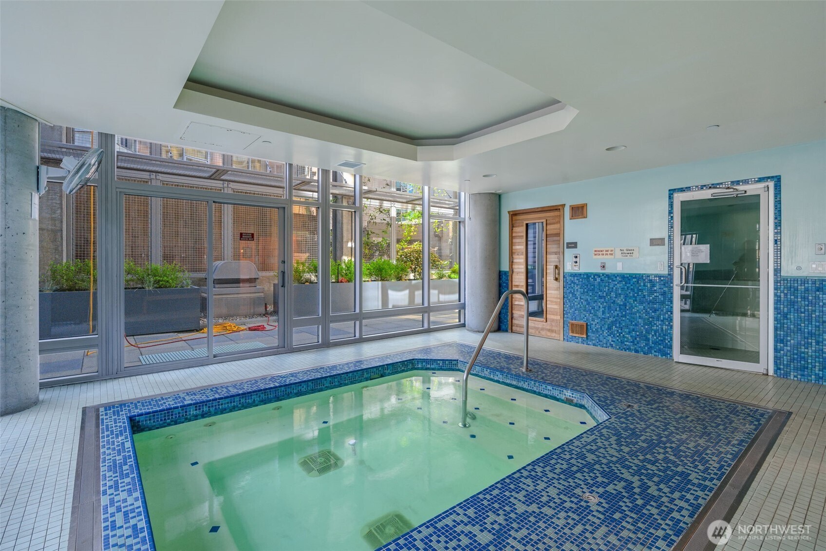 2033 2nd Avenue, Unit 1111 Seattle, WA 98121 - Photo 35 of 40 a swimming pool with outdoor seating and yard