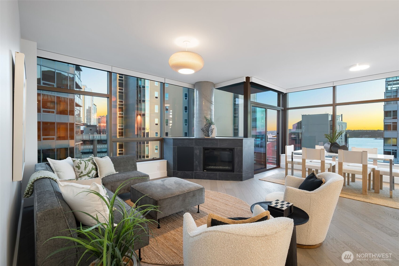 2033 2nd Avenue, Unit 1111 Seattle, WA 98121 - Photo 7 of 40 a living room with furniture large windows and wooden floor