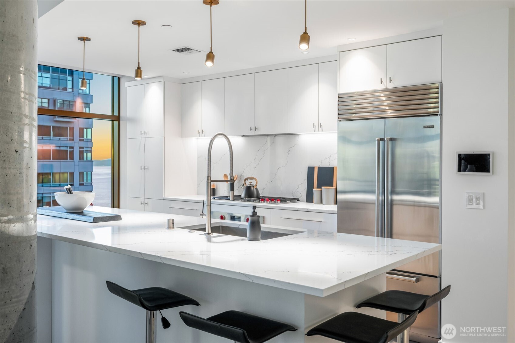 2033 2nd Avenue, Unit 1111 Seattle, WA 98121 - Photo 10 of 40 a kitchen with kitchen island a sink appliances and cabinets