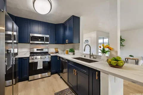 a kitchen with sink a microwave and cabinets