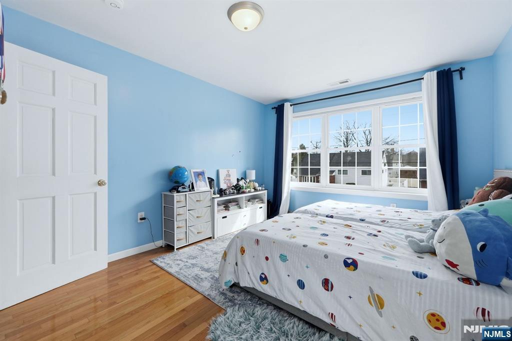 39 Voorhees Street Teaneck, NJ 07666 - Photo 20 of 47 a bedroom with a bed and a window
