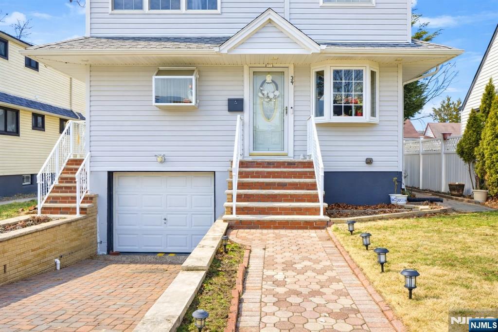 39 Voorhees Street Teaneck, NJ 07666 - Photo 2 of 47 a view of a house with a barbeque and wooden stairs