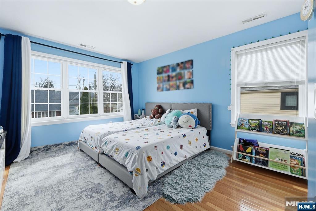 39 Voorhees Street Teaneck, NJ 07666 - Photo 21 of 47 a bedroom with a bed a dresser next to a window