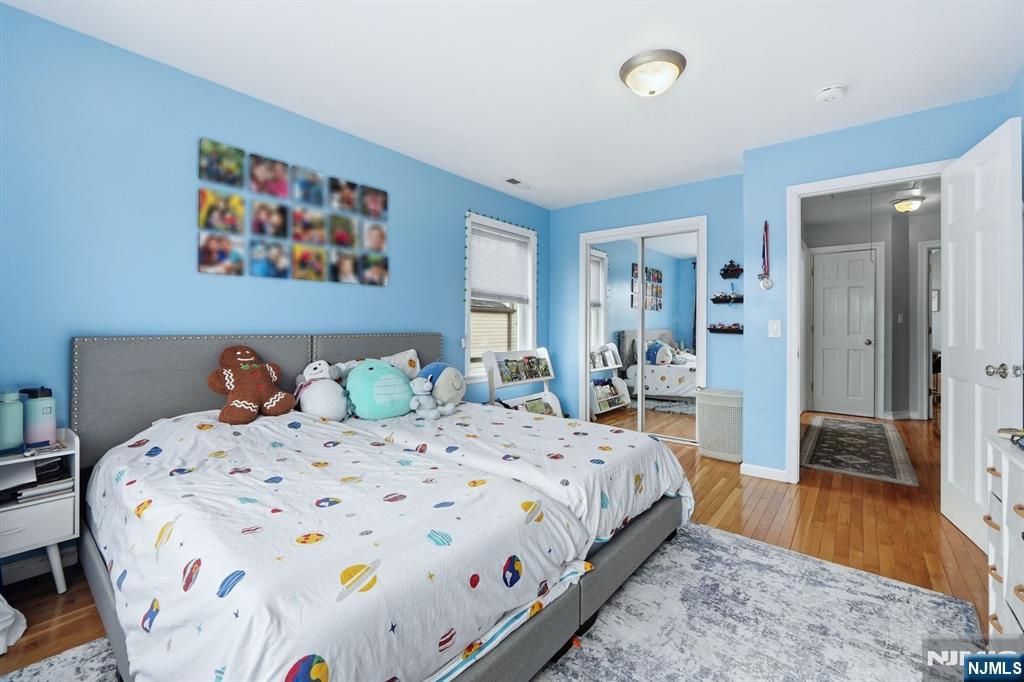 39 Voorhees Street Teaneck, NJ 07666 - Photo 22 of 47 a bedroom with a bed and a table