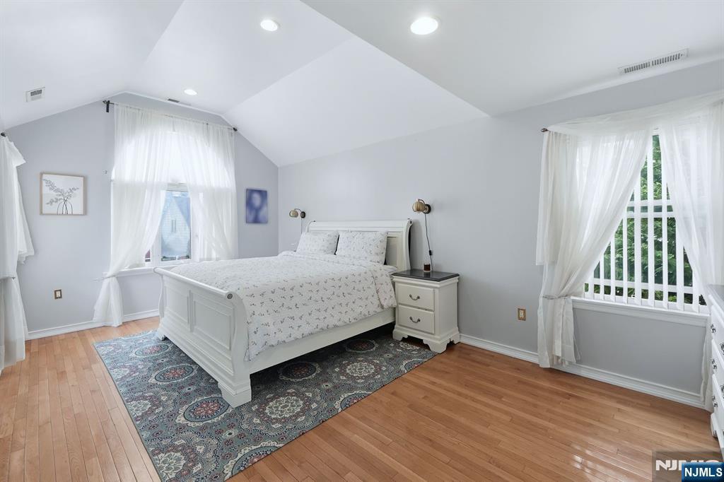 39 Voorhees Street Teaneck, NJ 07666 - Photo 24 of 47 a bedroom with a bed and wooden floor