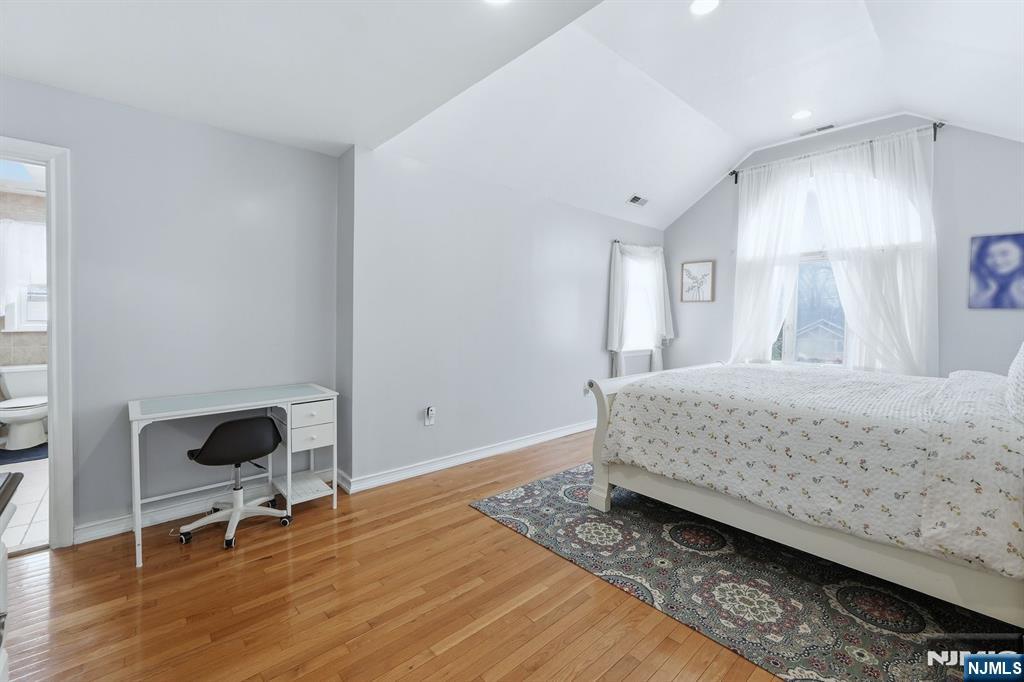 39 Voorhees Street Teaneck, NJ 07666 - Photo 26 of 47 a bedroom with a bed and a chair