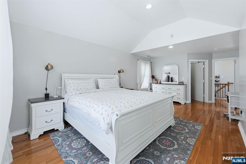 39 Voorhees Street Teaneck, NJ 07666 - Photo 27 of 47 a spacious bedroom with a bed and glass table