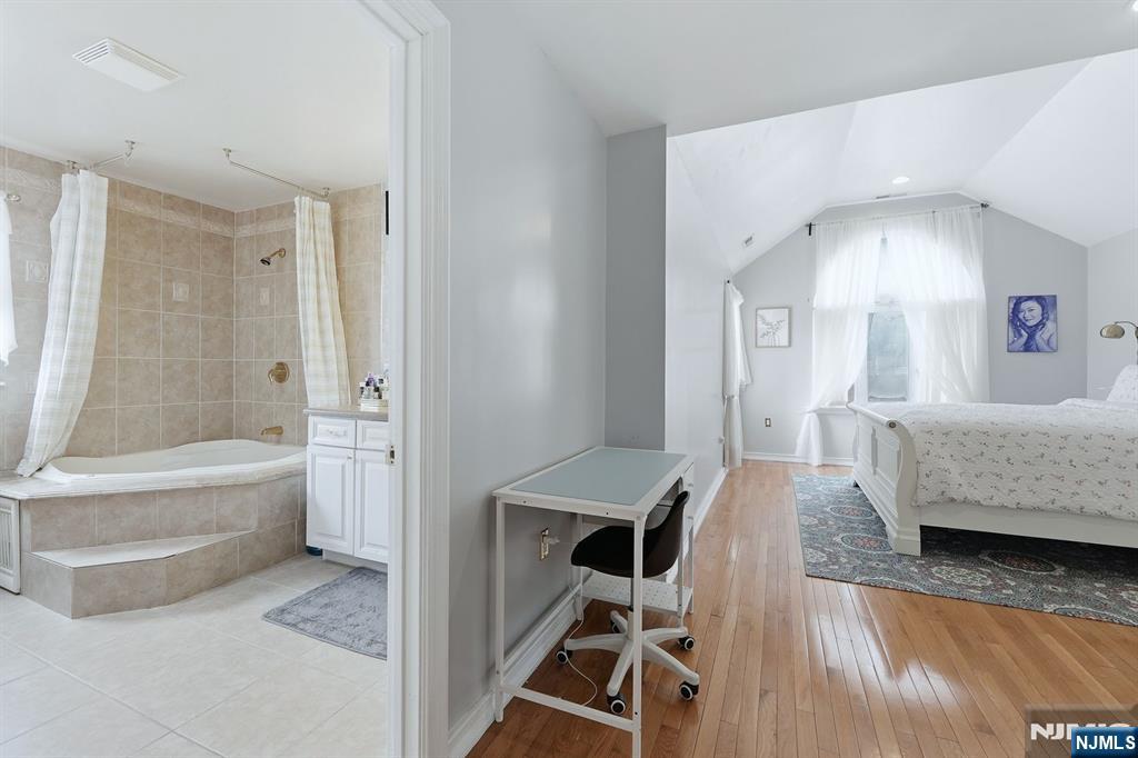 39 Voorhees Street Teaneck, NJ 07666 - Photo 29 of 47 a en suite bathroom with a tub double vanity and window