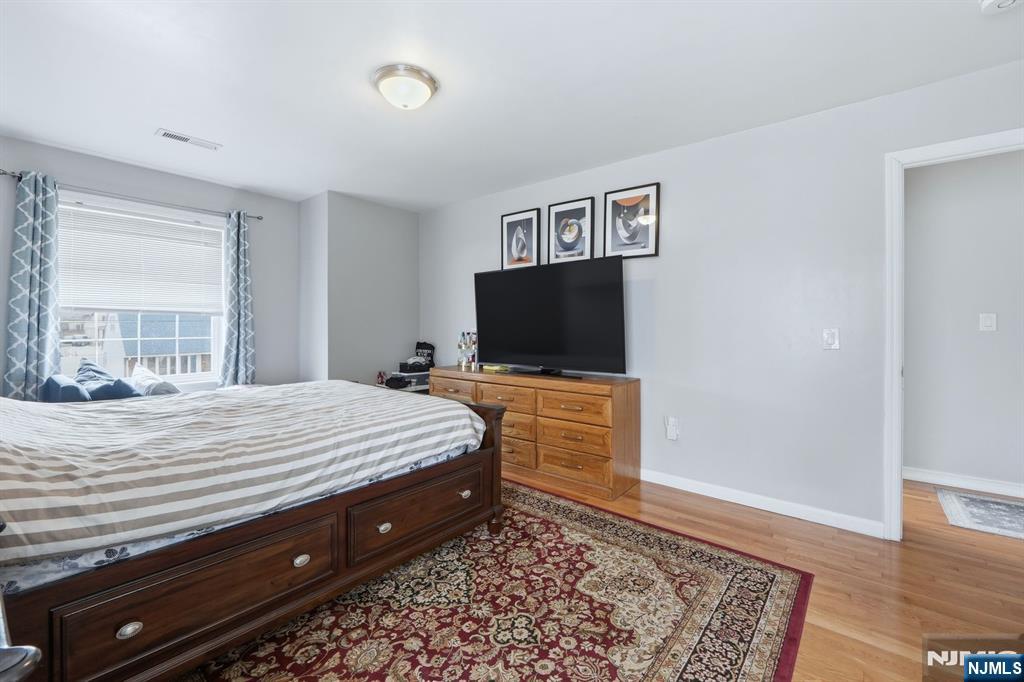 39 Voorhees Street Teaneck, NJ 07666 - Photo 33 of 47 a bed room with a bed and a television