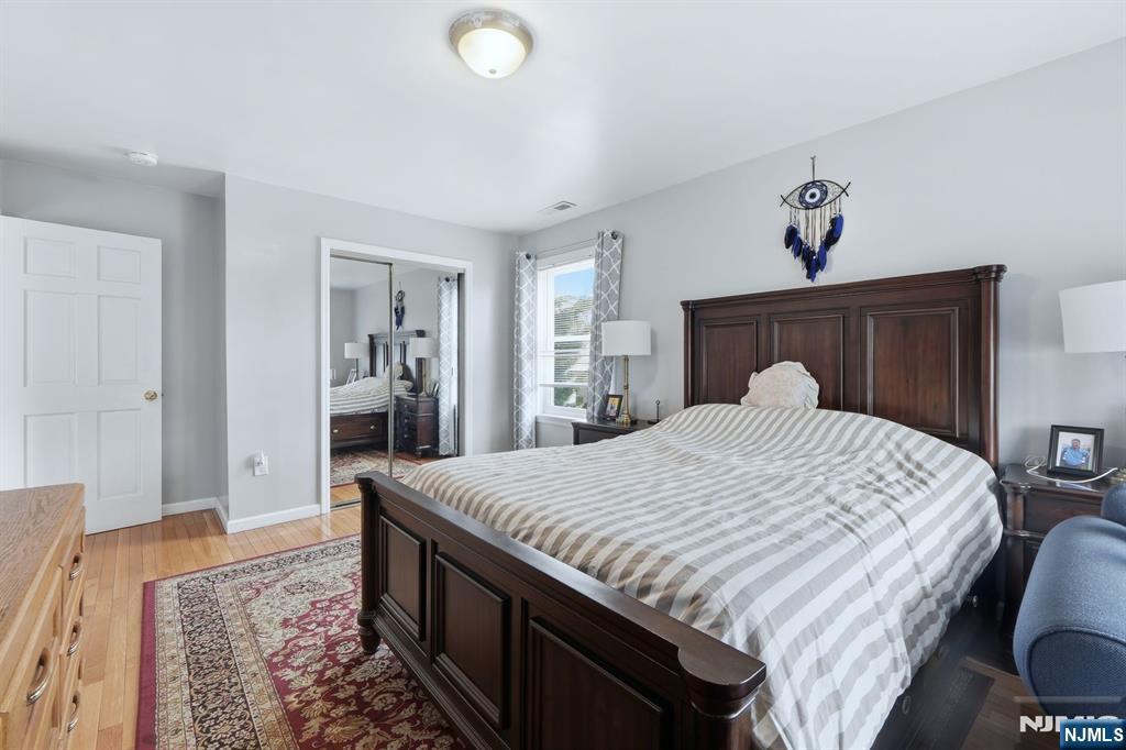 39 Voorhees Street Teaneck, NJ 07666 - Photo 34 of 47 a spacious bedroom with a bed and a dresser
