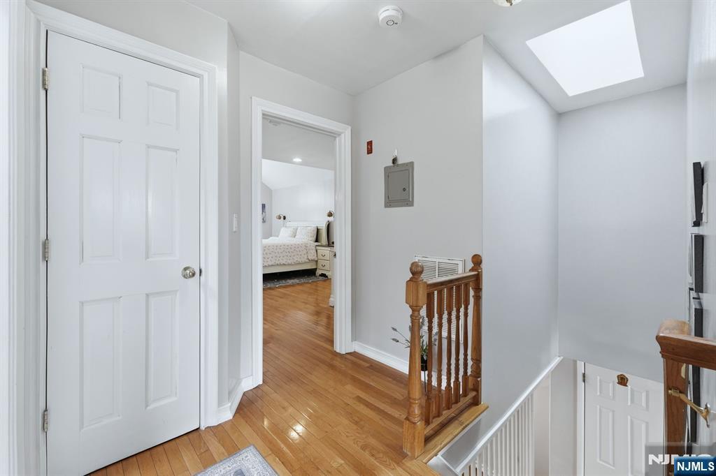39 Voorhees Street Teaneck, NJ 07666 - Photo 35 of 47 a view of a hallway with wooden floor and staircase