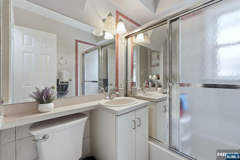 39 Voorhees Street Teaneck, NJ 07666 - Photo 36 of 47 a bathroom with a sink and a mirror