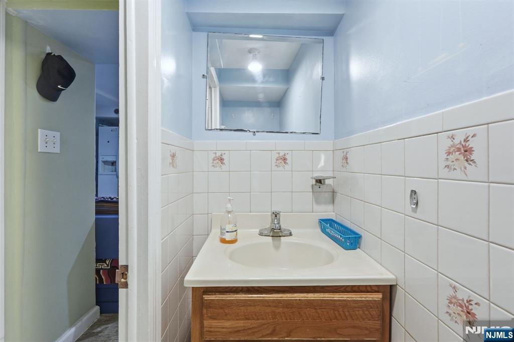 39 Voorhees Street Teaneck, NJ 07666 - Photo 40 of 47 a bathroom with a sink and a mirror