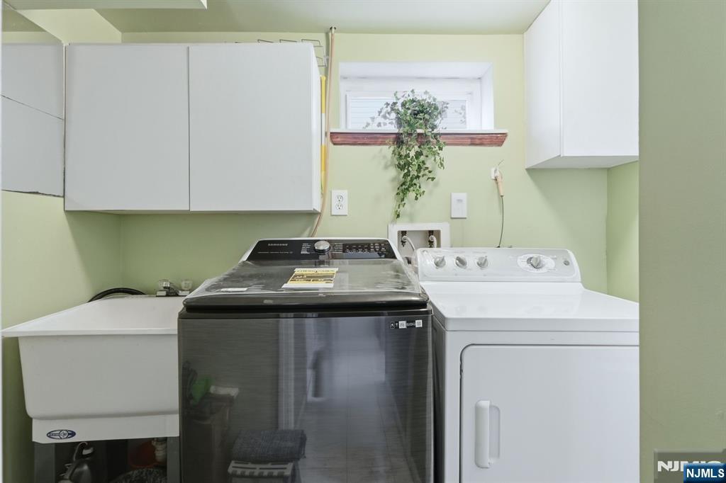 39 Voorhees Street Teaneck, NJ 07666 - Photo 43 of 47 a utility room with dryer and washer