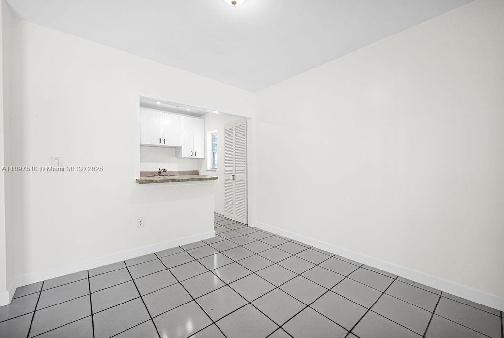 5960 Southwest 47th Street, Unit 1 Miami, FL 33155 - Photo 13 of 39 a room with a white cabinet and a stove top oven
