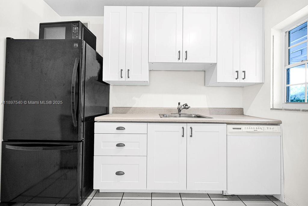 5960 Southwest 47th Street, Unit 1 Miami, FL 33155 - Photo 15 of 39 a kitchen with granite countertop white cabinets and refrigerator
