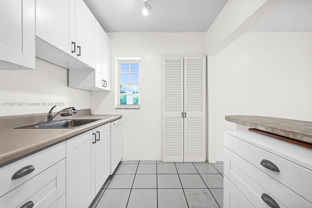 5960 Southwest 47th Street, Unit 1 Miami, FL 33155 - Photo 17 of 39 a kitchen with a sink and cabinets