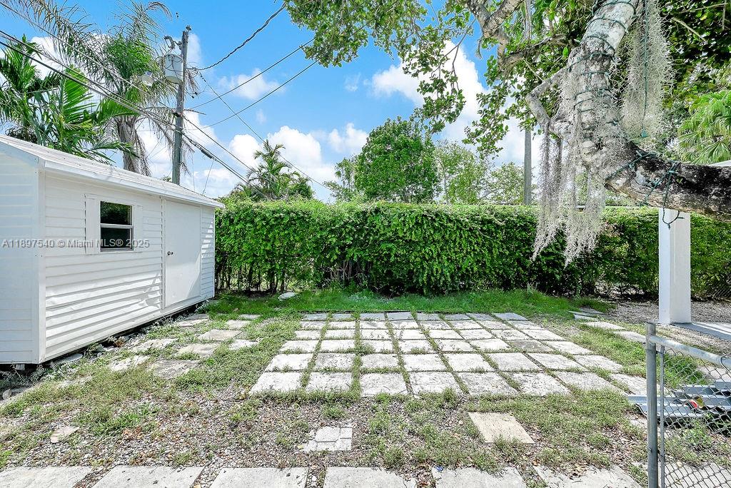 5960 Southwest 47th Street, Unit 1 Miami, FL 33155 - Photo 19 of 39 a view of a yard with plants and large trees