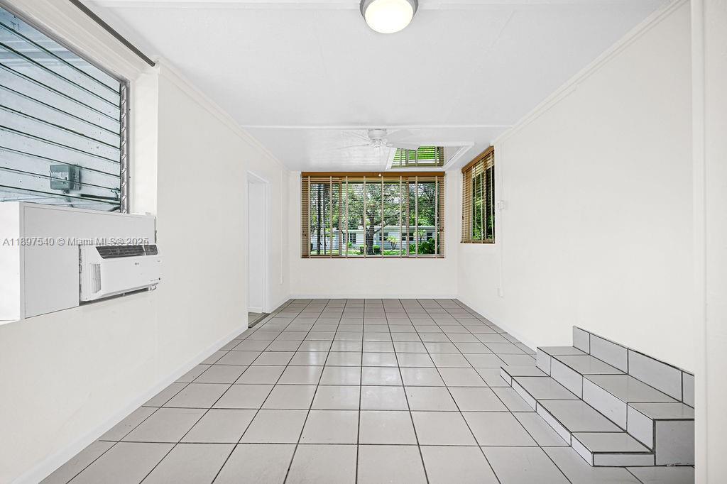 5960 Southwest 47th Street, Unit 1 Miami, FL 33155 - Photo 23 of 39 an empty room with windows