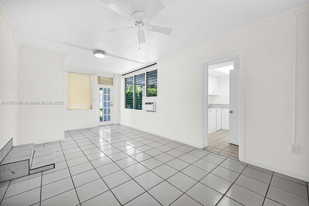 5960 Southwest 47th Street, Unit 1 Miami, FL 33155 - Photo 25 of 39 a view of an empty room with window and chandelier fan