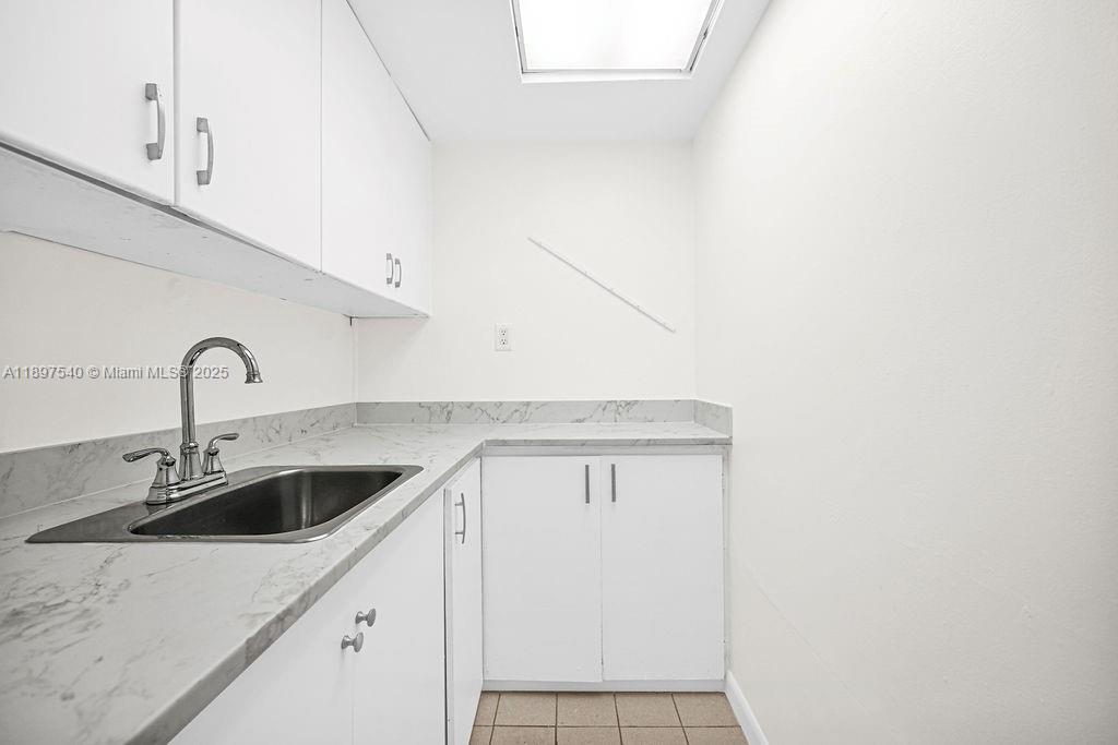 5960 Southwest 47th Street, Unit 1 Miami, FL 33155 - Photo 28 of 39 a kitchen with a sink and cabinets