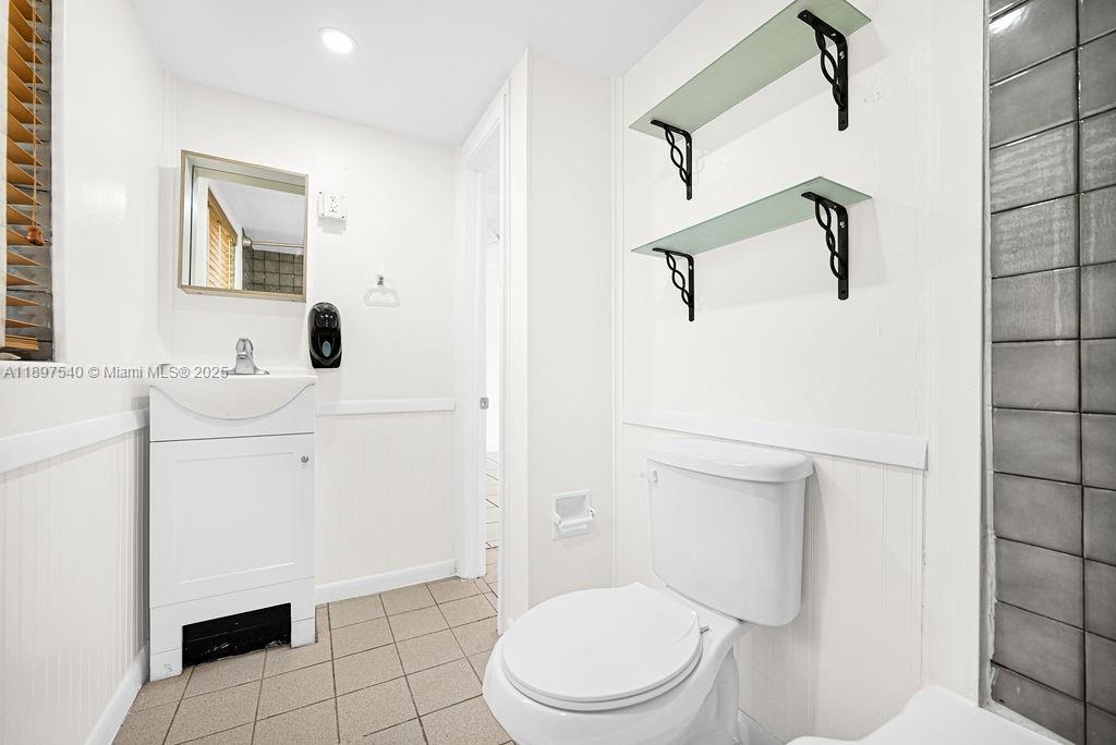5960 Southwest 47th Street, Unit 1 Miami, FL 33155 - Photo 32 of 39 a white toilet sitting next to a bathroom sink