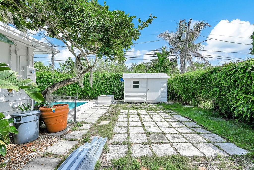 5960 Southwest 47th Street, Unit 1 Miami, FL 33155 - Photo 34 of 39 a backyard of a house with lots of green space and plants