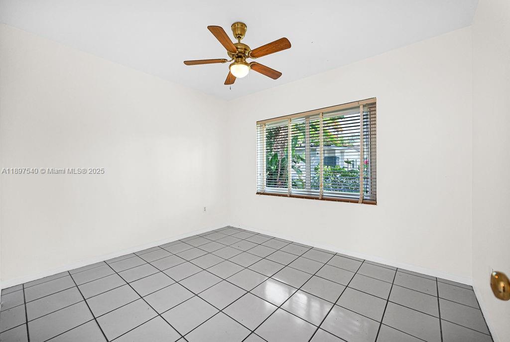 5960 Southwest 47th Street, Unit 1 Miami, FL 33155 - Photo 8 of 39 a view of an empty room and window