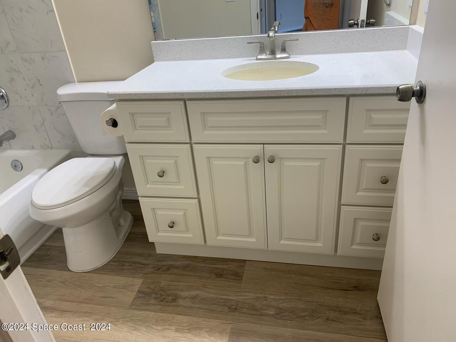 7667 North Wickham Road, Unit 710 Melbourne, FL 32940 - Photo 11 of 23 a bathroom with a sink toilet and vanity