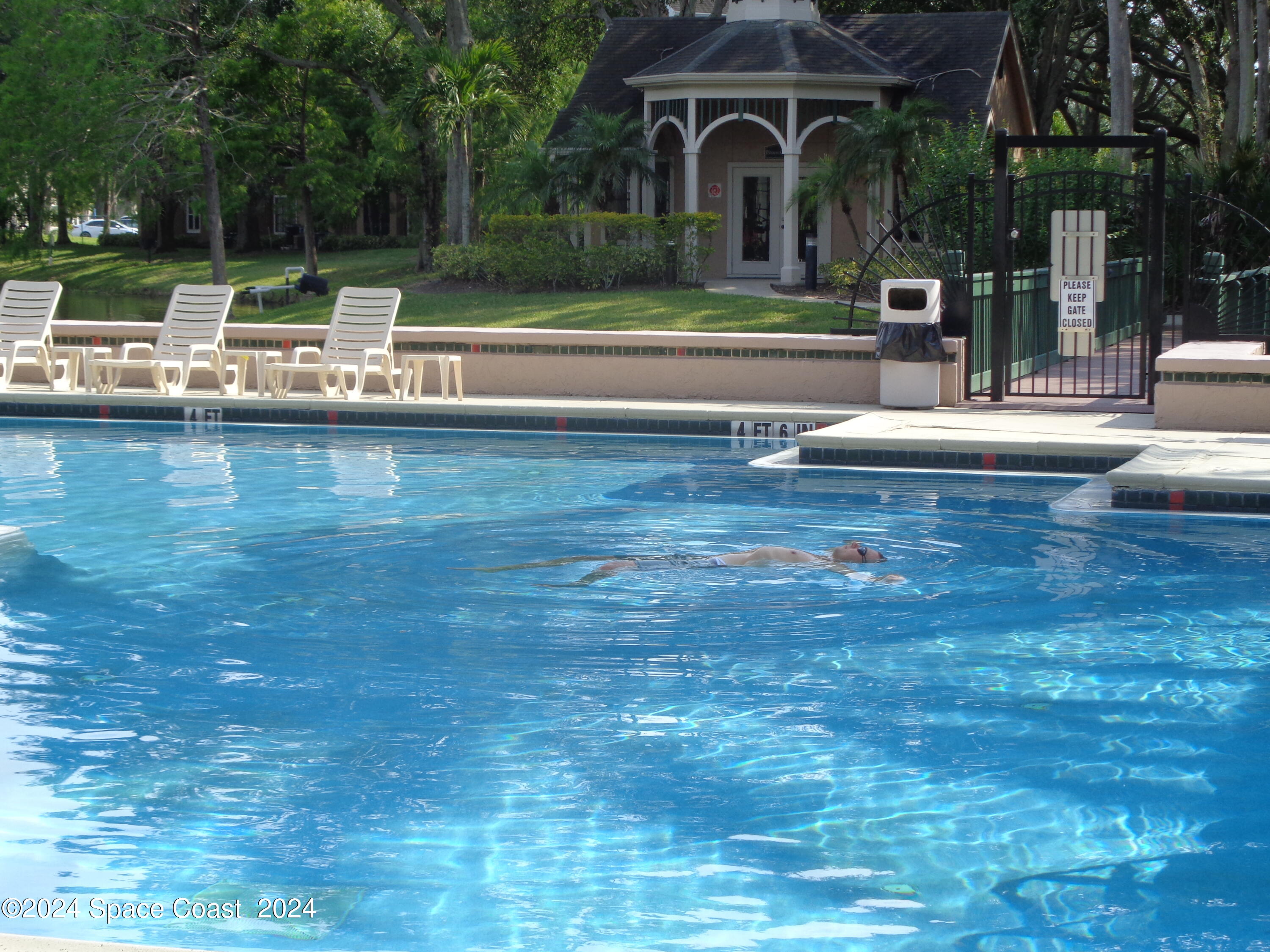 7667 North Wickham Road, Unit 710 Melbourne, FL 32940 - Photo 23 of 23 a view of a swimming pool with a patio