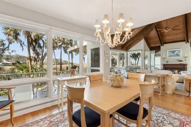 a dining table with chairs and chandelier
