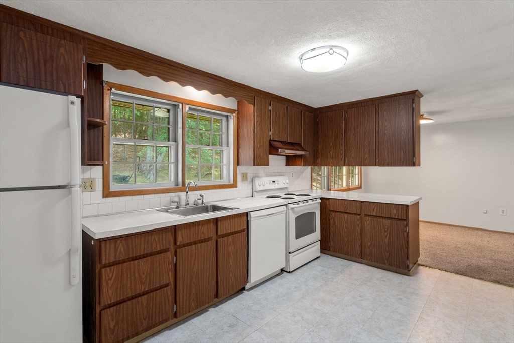 16 Larnis Road Framingham, MA 01701 - Photo 5 of 17 a kitchen with stainless steel appliances granite countertop a sink stove and refrigerator