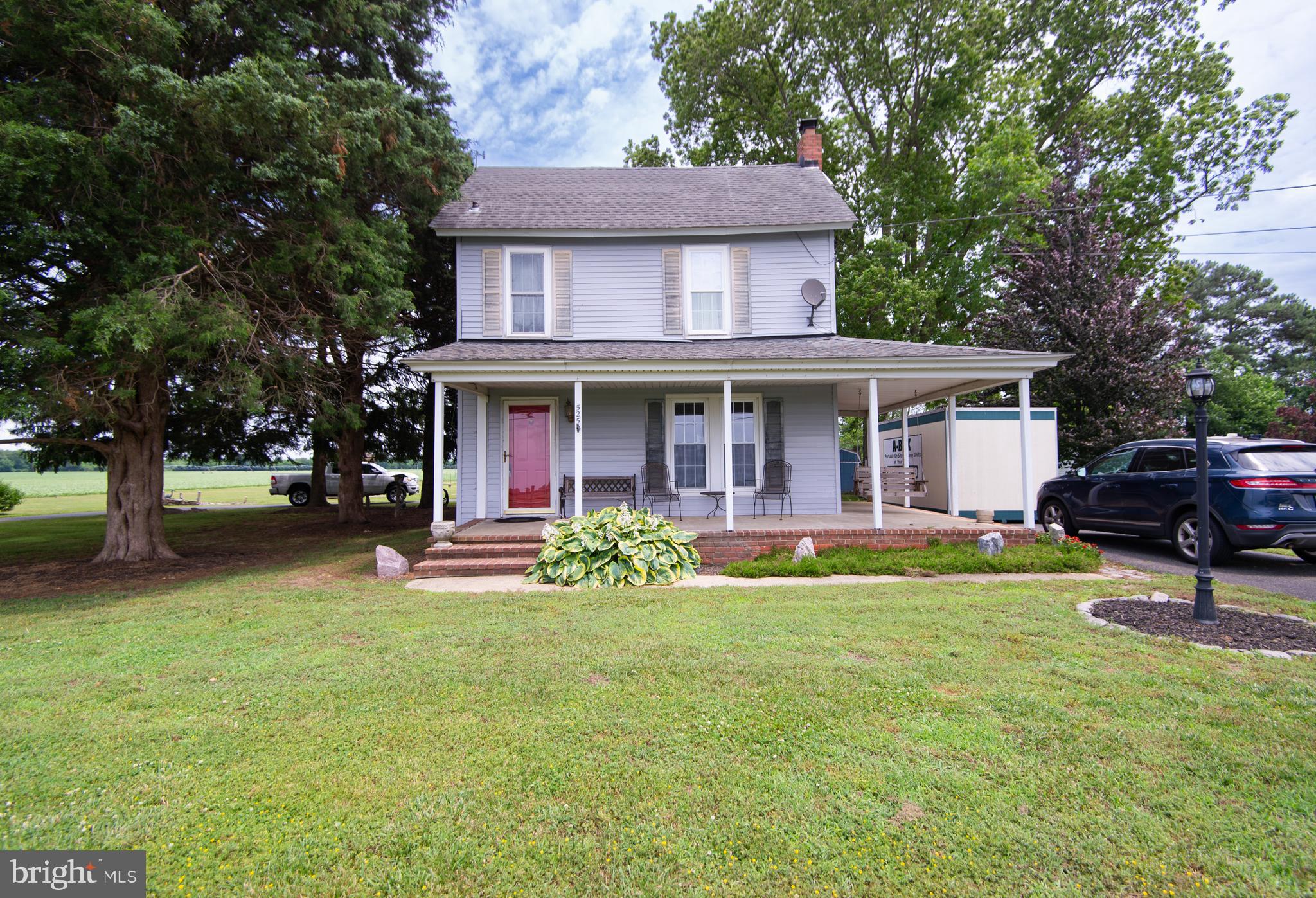 a view of a house with a yard porch and sitting area