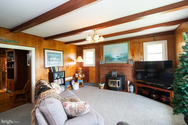 a kitchen that has a lot of white cabinets and wooden floor