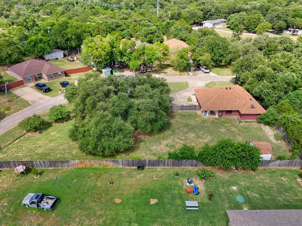 7 Market Loop Morgan's Point Resort, TX 76513 - Photo 28 of 31 Expansive property featuring a red brick house with a brown shingled roof, a paved driveway, and mature landscaping