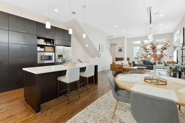 a large kitchen with a table and chairs