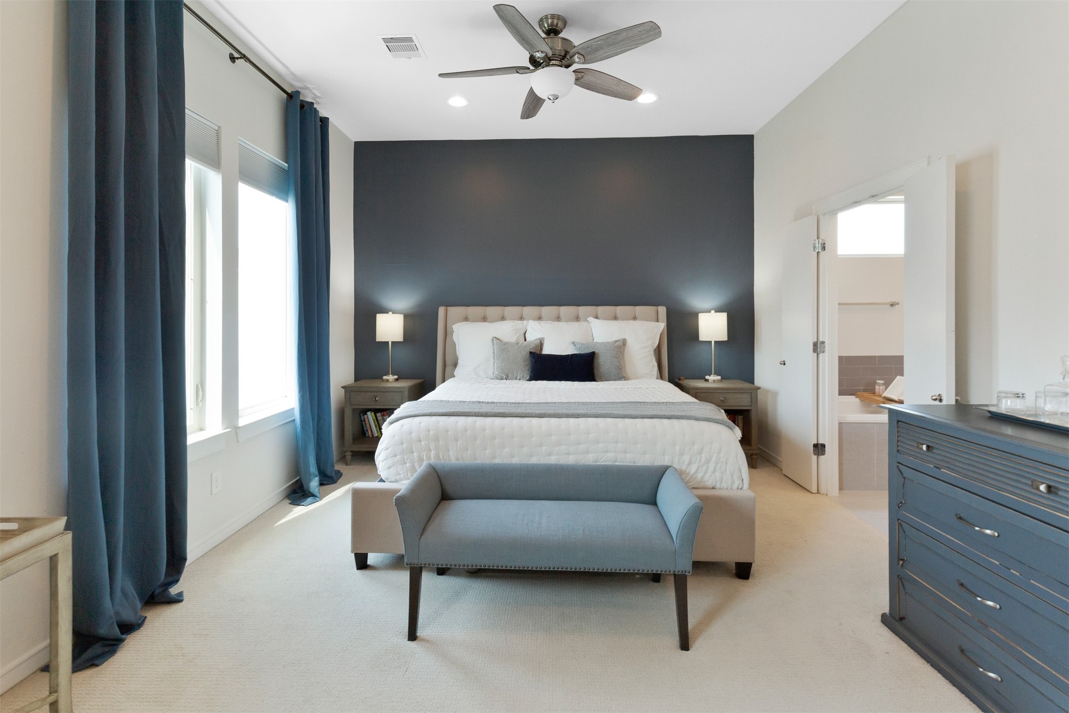 1308 Delano Street Houston, TX 77003 - Photo 14 of 24 a bedroom with a large bed and a chandelier