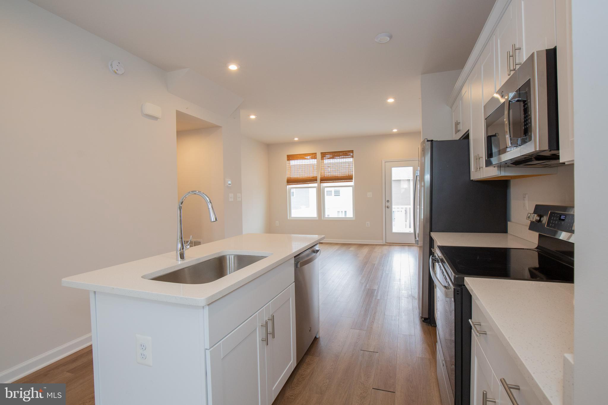 80 Anthem Street Ranson, WV 25438 - Photo 11 of 30 a kitchen with stainless steel appliances granite countertop a sink a stove and a wooden floors