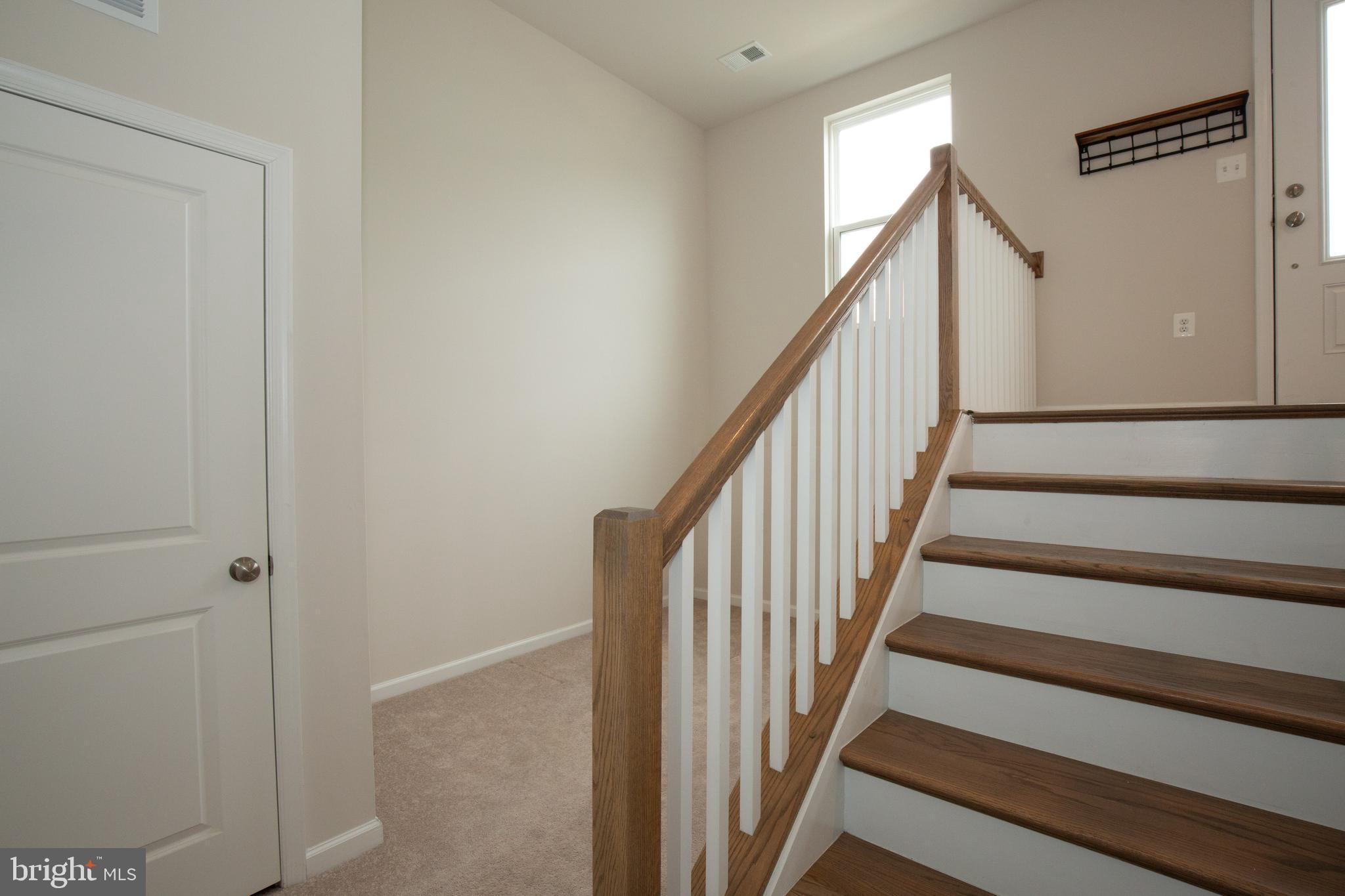 80 Anthem Street Ranson, WV 25438 - Photo 26 of 30 a view of staircase with wooden floor and white walls