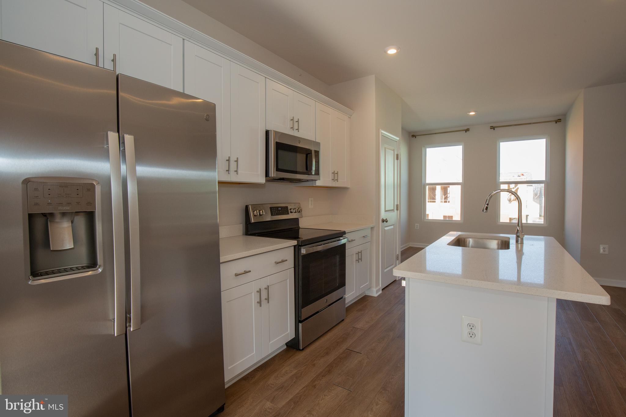 80 Anthem Street Ranson, WV 25438 - Photo 6 of 30 a kitchen with refrigerator a sink and cabinets