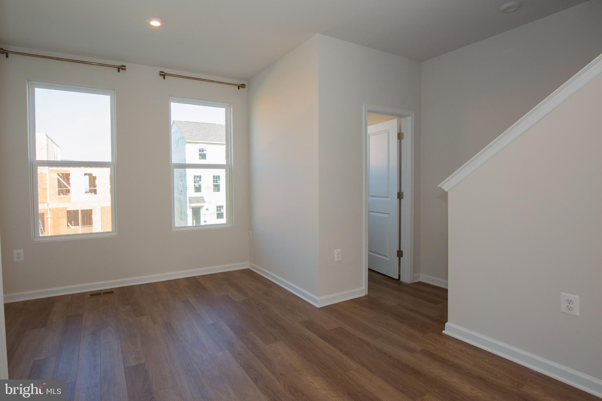 80 Anthem Street Ranson, WV 25438 - Photo 8 of 30 an empty room with wooden floor and windows