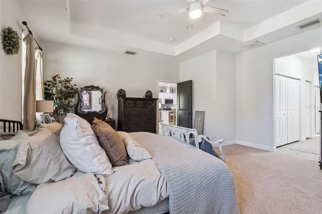 a bedroom with a bed and a chandelier