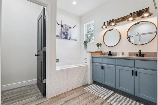 a bathroom with a granite countertop sink mirror and vanity