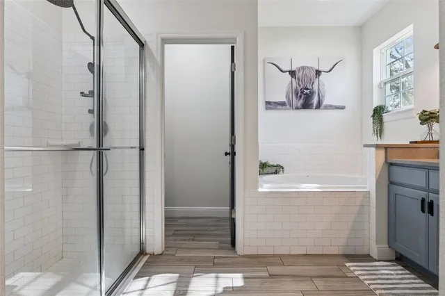 a bathroom with a bathtub and shower