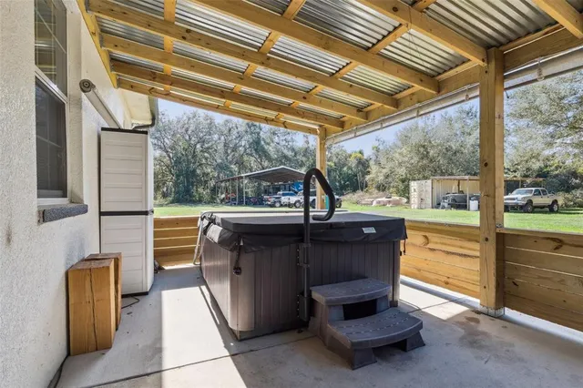 a view of a house with a backyard porch and sitting area