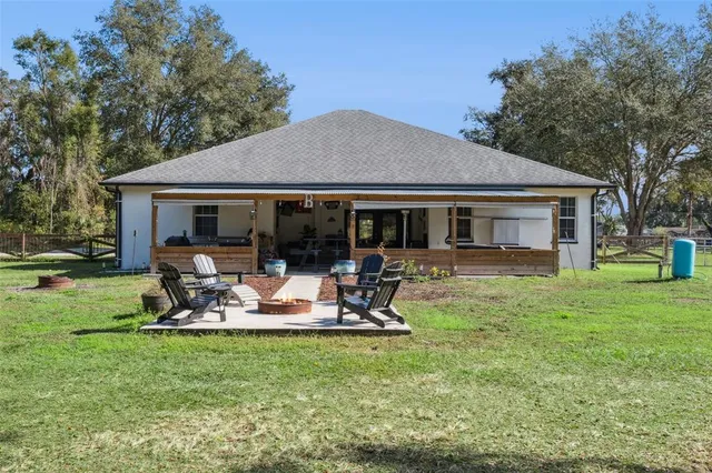 a view of a house with swimming pool and sitting area
