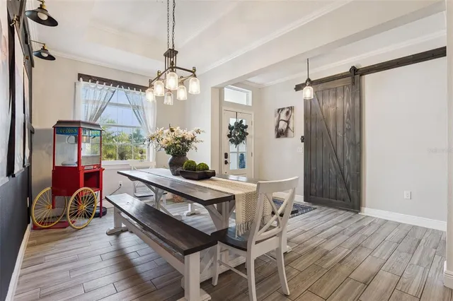 a view of a dining room with furniture window and wooden floor