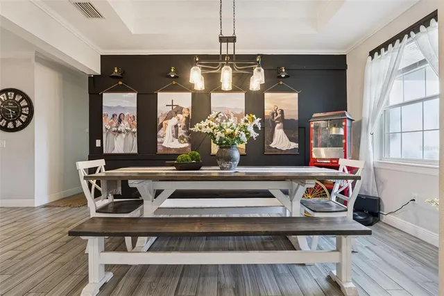 a view of a dining table chairs and chandelier